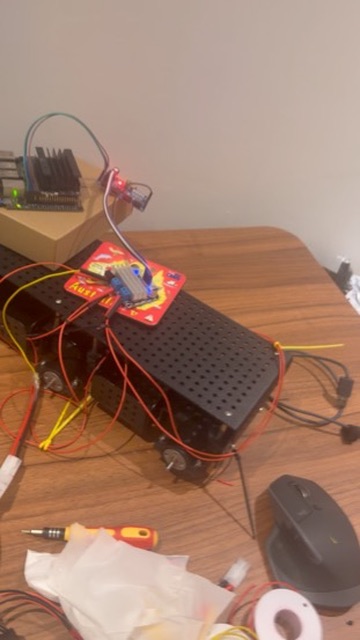 Chassis on a desk with the Jetson, PCA9685 and loose wiring during the first wheel test