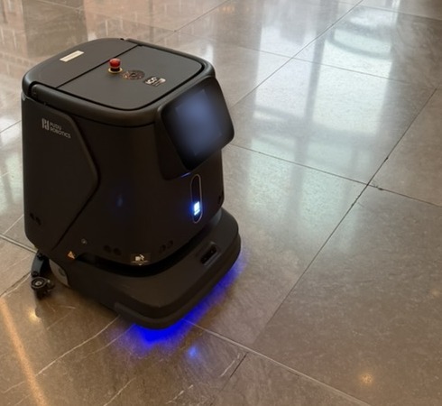 Autonomous floor-cleaning robot in a shopping centre