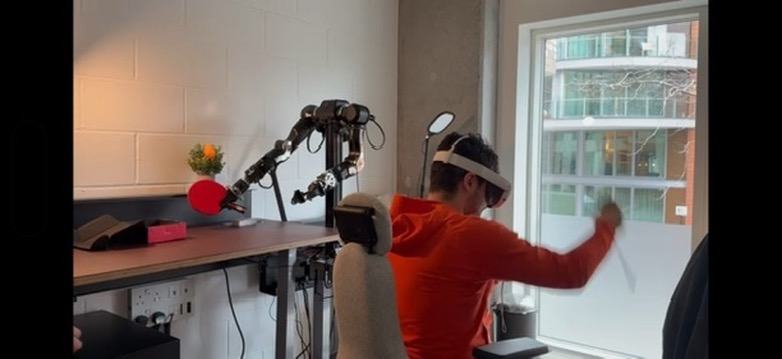 Person in a VR headset teleoperating a robot arm